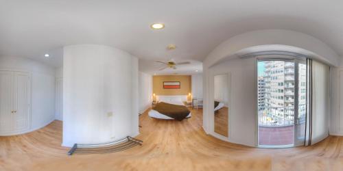 a large room with a large window and a bedroom at Hotel Miño in Ourense