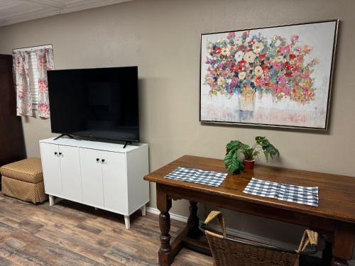 a living room with a tv and a table with a table at Studio near Lake Weatherford, Eagle Mountain & Lake Worth in Azle