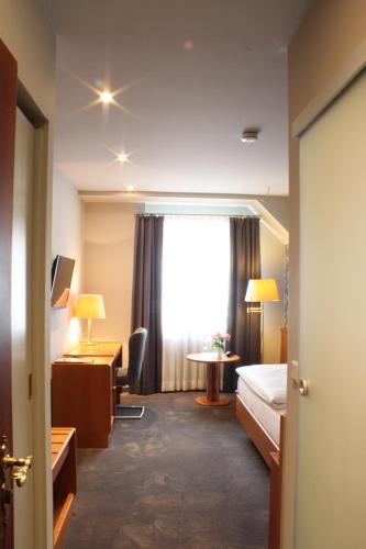 Ένα ή περισσότερα κρεβάτια σε δωμάτιο στο Hotel Kloppenborg