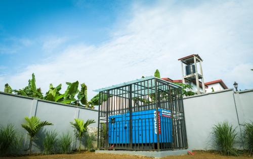 a blue door in a cage on the side of a fence at La Source, Kribi in Kribi