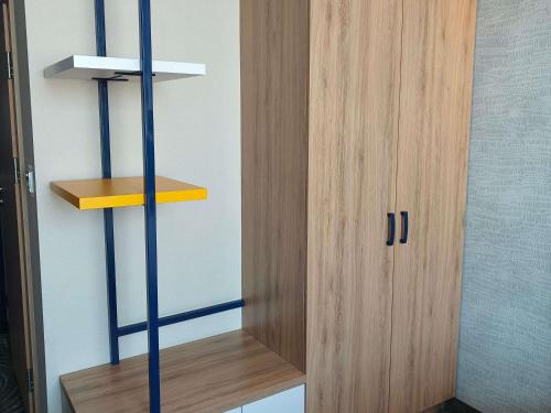 a room with a wooden shelf and a wooden cabinet at ibis styles Bolesławiec in Bolesławiec