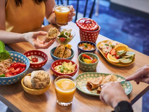 a group of people sitting at a table with food at ibis styles Bolesławiec in Bolesławiec