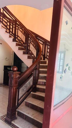 a wooden spiral staircase in a house with a window at HOTEL ROOMS new MP GUEST INN in Nellore
