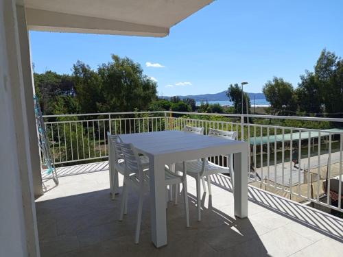 a white table and chairs on a balcony at Solleone - Appartamento 9C in Paestum