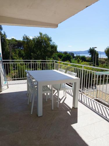 a white table and chairs on a balcony at Solleone - Appartamento 9C in Paestum