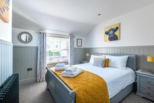 En eller flere senge i et værelse på Postmans Cottage