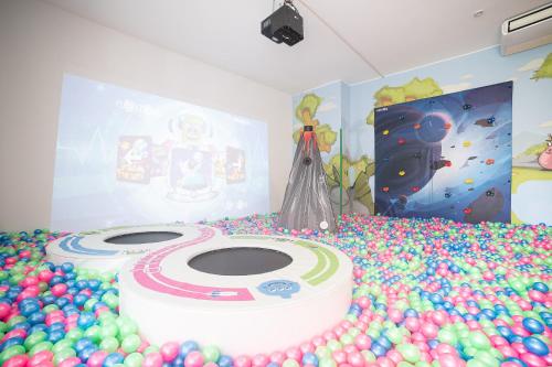a birthday party with a cake and balloons on the floor at Hotel Relax Family & Spa in San Benedetto del Tronto