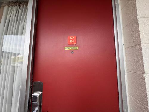 a red door with a sign on it at Edyn Hotel By Townhouse Wytheville US 52 in Wytheville