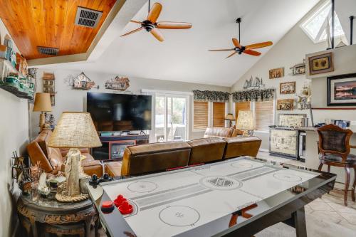 a living room with a ping pong table at Port Clinton Home with Private Dock and Gazebo! in Port Clinton
