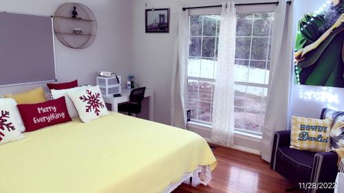 a bedroom with a yellow bed and a window at Berni Oasis in Hampton