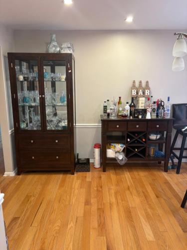 a room with a cabinet and a wooden floor at Berni Oasis in Hampton