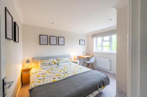 a bedroom with a bed and a desk and a window at 2 Mallard Cottages 4 in Tattersett