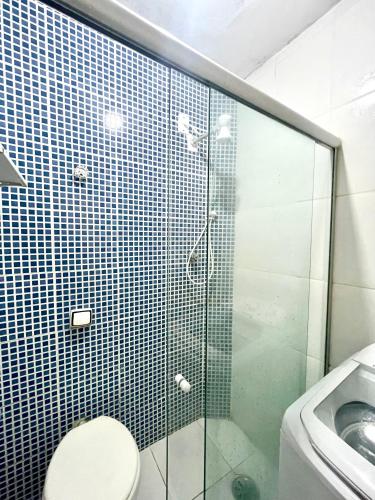 a bathroom with a shower with a toilet and a sink at Studio Infinity Beach in São Vicente