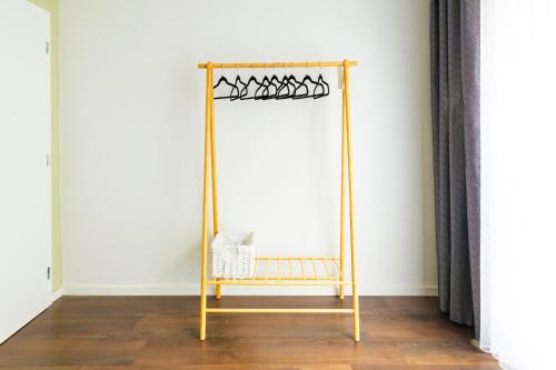 a gold stand with a basket on it in a room at Olive Stays Apartment - 2 in Pristina