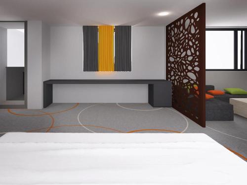 a room with a bed and a couch at Ibis Styles Bucharest Airport in Otopeni