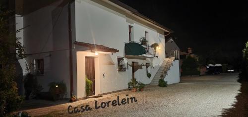 a white building with a sign on the side of it at Casa Lorelein in Pieve di Soligo