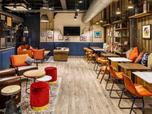 a restaurant with tables and chairs in a room at ibis Budget Sheffield Centre St Marys Gate in Sheffield