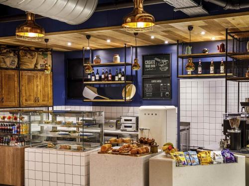 a kitchen with blue walls and a counter with food at ibis Budget Sheffield Centre St Marys Gate in Sheffield
