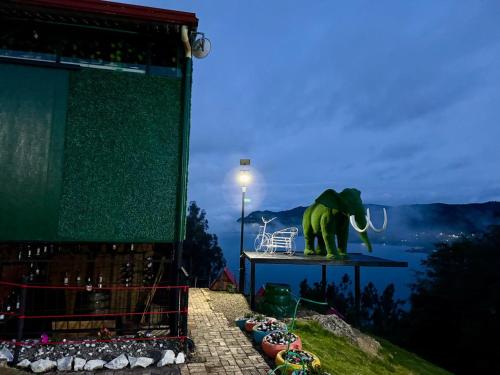 a statue of an elephant on a table in front of a stage at SAN ALEJO- CABAÑAS Y CAMPING in Tota