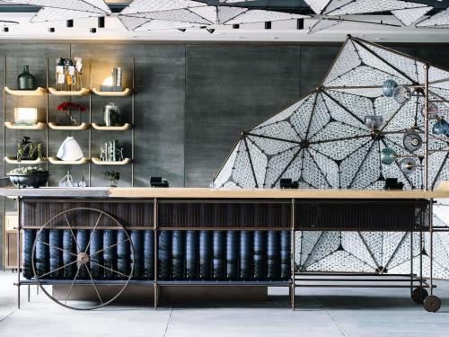 a room with a counter with a wall with a large wall at Mercure Kyoto Station in Kyoto
