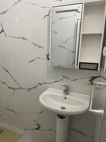 a bathroom with a sink and a mirror at Durrës Beach Apartments in Durrës