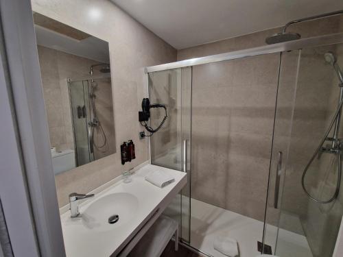 a bathroom with a sink and a shower at Virgen de los Reyes in Seville