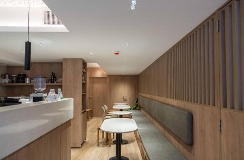 a restaurant with wooden walls and tables and chairs at Cyan Hotel de Las Americas in Buenos Aires