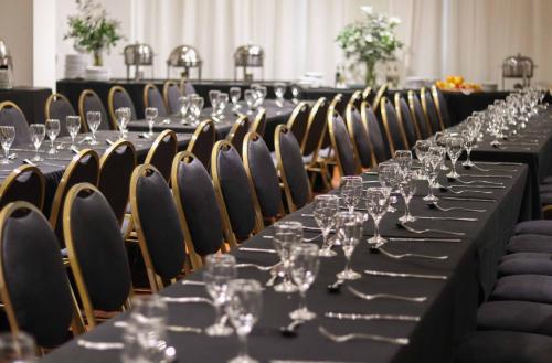 a long table with wine glasses on it at Cyan Hotel de Las Americas in Buenos Aires
