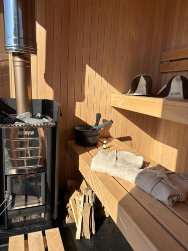 a kitchen with a woodburning stove in a room at Laughing Seagull Cottage - Sea Views and Sauna in Castletownbere