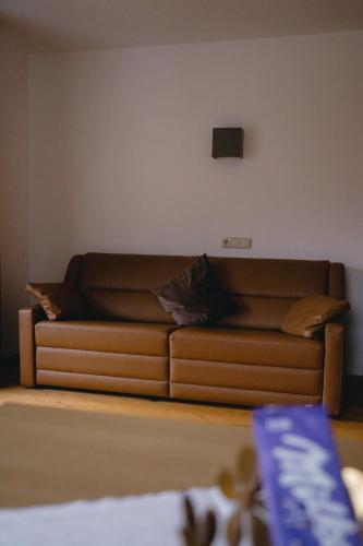 a brown couch sitting in a living room at Eckis Appartements in Schruns