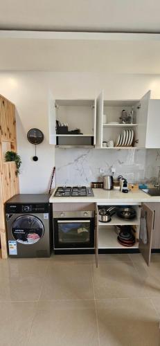 a kitchen with a stove and a stove top oven at Appartement t2 neuf en residence ,dakar in Dakar