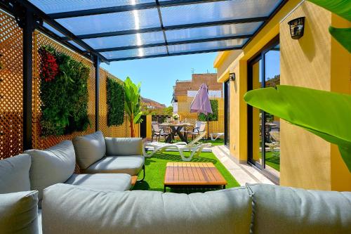 a living room with a couch and a table on a patio at La huerta centro in Alicante