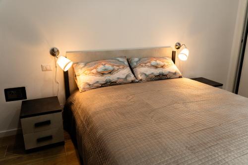 a bedroom with a bed with two lamps on it at Orfeo Guest House in Bari