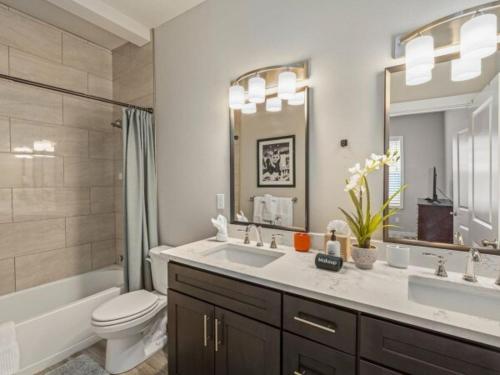 a bathroom with a sink and a toilet and a mirror at The Meadow in Tacoma