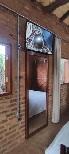 a room with a wooden wall with a door and a window at Cabana Rústica da Natureza in Jundiaí