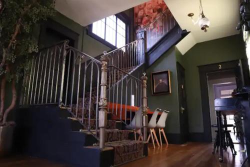 a staircase in a living room with a stair case at Stylish Casa Mina Downtown Free Parking in El Paso