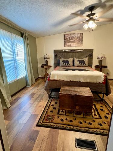 a bedroom with a large bed with a wooden headboard at Black Bear Hideaway in Pickens
