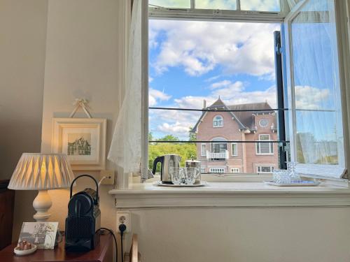 a window with a view of a building at Hotel Molendal in Arnhem