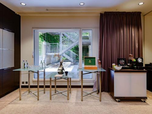 a kitchen with a table with a laptop on it at Mövenpick Hotel Lausanne in Lausanne