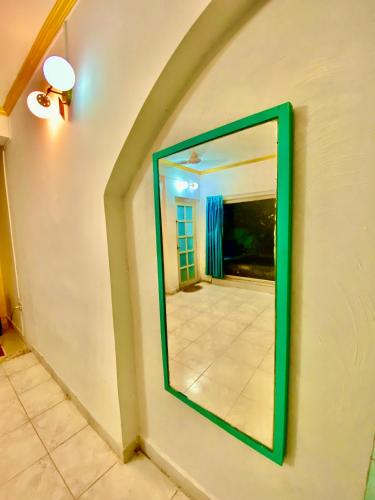 a green mirror on a wall with a hallway at Villa Greek Baga 4Bhk Villa with private Pool & Kitchen in Calangute