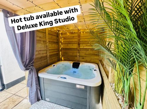 a hot tub available with a deluxe king studio at Holyland House - Greenacres Estates in Pembrokeshire