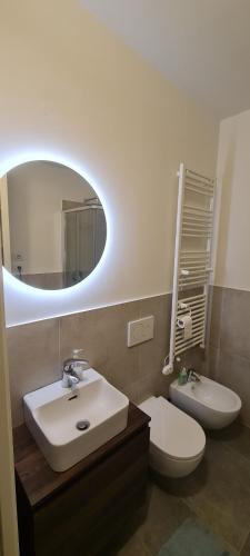 a bathroom with a sink and a toilet and a mirror at Mountain View Room in Milan
