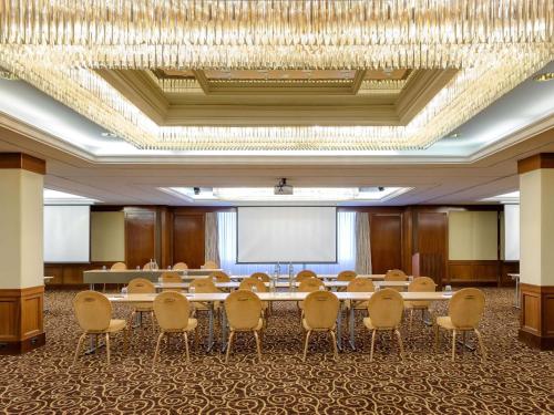 a conference room with a large table and chairs at Mövenpick Hotel Geneva in Geneva