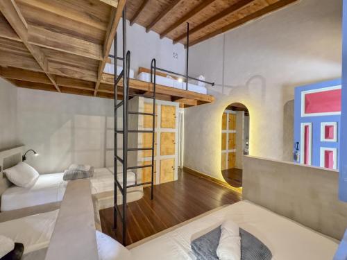 a bedroom with a loft bed and a staircase at Dreamer Cocora in Salento