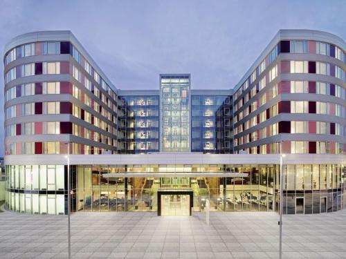 a rendering of a large office building with a courtyard at Mövenpick Hotel Stuttgart Airport in Stuttgart