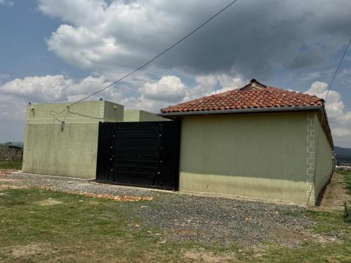 a garage with a black gate and a building at Tano Bora Villa in Sekenani