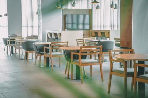 a row of tables and chairs in a restaurant at Crowne Plaza Merida by IHG in Mérida