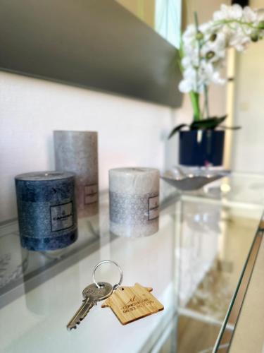 a pair of keys on a glass table with candles at Maison Villa Sables-d'Olonne in Les Sables-d'Olonne