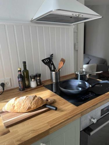 a loaf of bread on a cutting board on a kitchen counter at Lovely appartment in charming town house in Assens