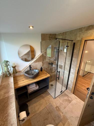 a bathroom with a sink and a shower at Panorama Lodge Bergblick in Salzburg